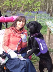 A picture of a woman in a wheelchair (Sally) with her assistance dog, Ethan.