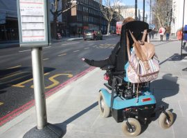 Emma Vogelmann in her wheelchair waiting for a bus